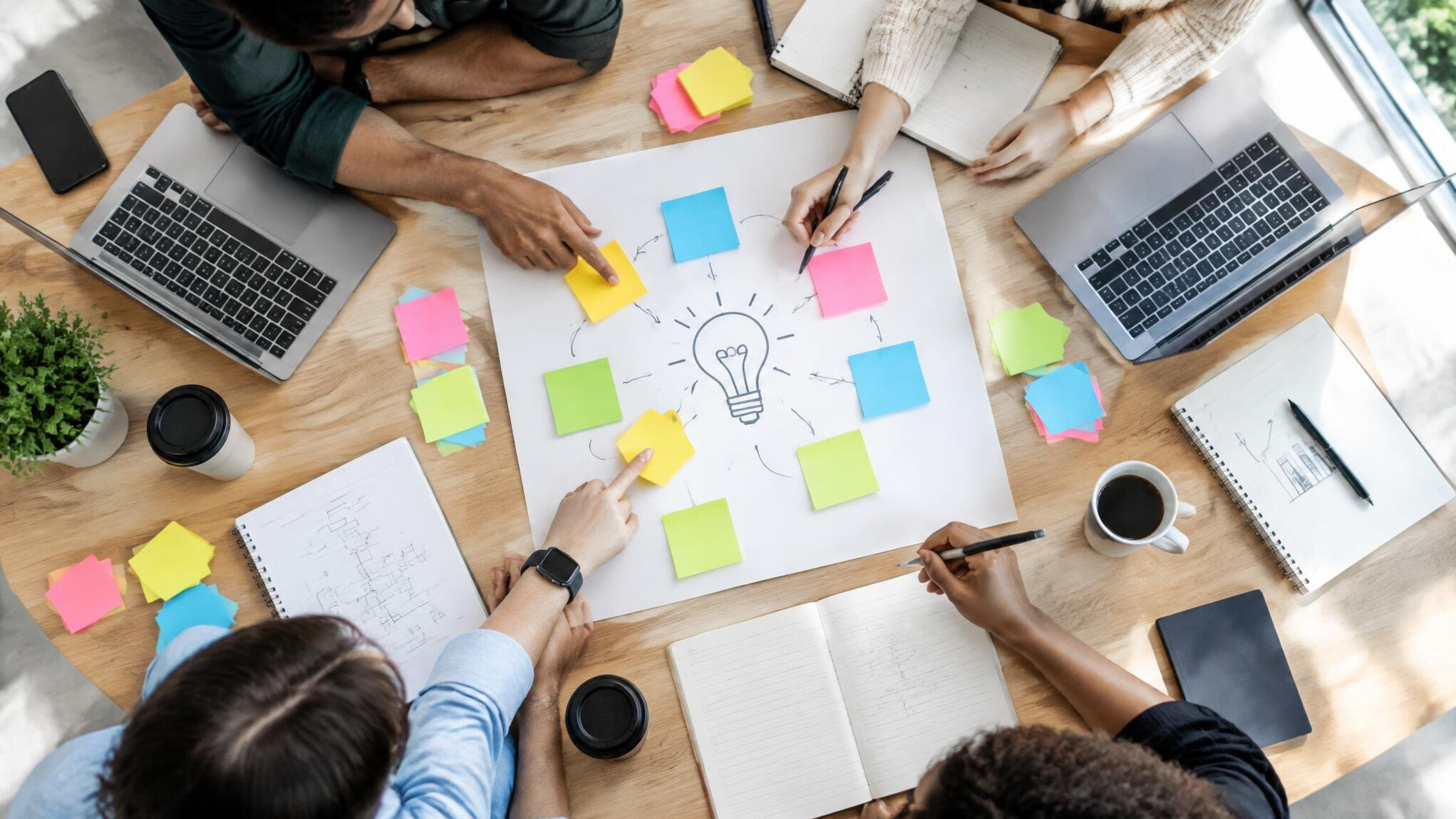 Team members brainstorming with sticky notes on a table